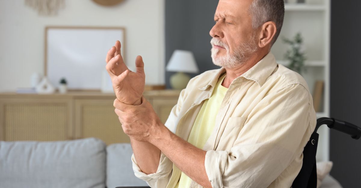 uomo si tiene una mano dolorante