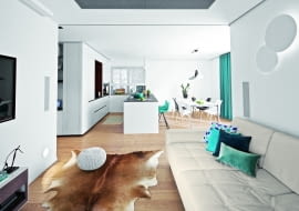 Na otwartą strefę dzienną składa się przedpokój, kuchnia z jadalnią i salon. Takie rozwiązanie sprzyja rodzinnej integracji; większość czasu domownicy spędzają w strefie dziennej. Na sofie Maxdivani poduszki NAP oraz Bo Concept, skóra na podłodze IKEA, puf House & More.