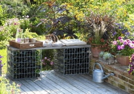 Selbstgebaute Bank aus Gabionen gefuellt mit leeren Flaschen , Toepfe mit Dahlia ( Dahlien ), Calibrachoa ( Zaubergloeckchen ), Graesern und Echeveria auf Mauer, Zink-Giesskanne, Katze liegt auf Kissen 61053230, 61053232 SLOWA KLUCZOWE: Sp tsommer draussen quer TERRASSE Topf msgnp12 000 Holzdeck SITZPLATZ BALKONBLUMEN K<BELPFLANZEN Tier