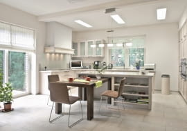 <B>Decyzja, gdzie postawić stół, powinna zależeć nie tylko od metrażu mieszkania i liczby pomieszczeń, ale także od stylu życia domowników. Wybierając miejsce na ten mebel, pamiętajmy o zachowaniu niezbędnych odległości: od ściany - ok. 80 cm, natomiast od regału albo komody - 100 cm. Na jedną osobę trzeba przeznaczyć ok. 60 cm długości blatu.</B> <BR >CENTRUM DOMOWE. Otwarta kuchnia i przestronny salon, a między nimi - aneks jadalny usytuowany przy wyspie. Rozwiązanie nie tylko wygodne, ale również sprzyjające zacieśnianiu więzów rodzinnych. <BR >Stół jest zrobiony z litego dębu zabejcowanego na brąz w szarawym odcieniu. Z jego masywną formą kontrastują lekkie krzesła na nóżkach-płozach wykonanych z cienkich stalowych rurek. <BR >Na co dzień część stołu jest wsunięta we wnękę w wyspie, dzięki czemu mebel zajmuje mniej miejsca.