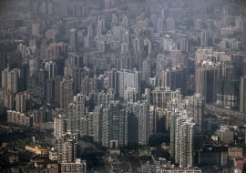 In this Dec. 7, 2010 photo, an aerial view of new residential area is seen in Shanghai, China. The country's commercial capital will impose a limited property tax to help curb surging prices, Shanghai's mayor says, describing good handling of housing as crucial for the city's future. (AP Photo/Eugene Hoshiko)