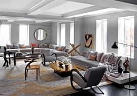 Podniebny salon o dwóch przeszklonych ścianach. Dywan utkano na zamówienie w firmie ABC Carpet & Home. Loftowe lampy przełamują miękką pastelową konwencję.