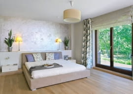 Dom miał być przytulny, urządzony z wyraźną przewagą naturalnych materiałów: drewna, wikliny i bawełny, ale też z nutą nowoczesności. Właścicielom, Monice i Adamowi, udało się spełnić to marzenie. <BR /> DOM. Sypialnia, podobnie jak cały dom, jest utrzymana w stonowanych brązach, beżach i bielach. Spokojny wystrój ożywiają kwiaty - zarówno te prawdziwe, jak i na tkaninach. Ścianę za łóżkiem wykończono tynkiem strukturalnym. Zabudowa z lakierowanego na biało drewna, pełniąca funkcję półki, kryje kable zasilające lampki.