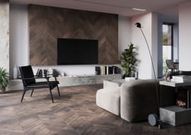 Podłoga FertigDeska Chevron Dąb Color Vento o wzorze jodły francuskiej, która świetnie komponuje się z industrialnymi akcentami matowej czerni i eleganckim kamieniem.