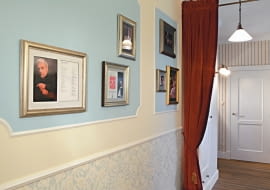 <B>Nie dość, że przedpokoje są zazwyczaj niezbyt duże i wąskie, to w dodatku funkcjonalne zagospodarowanie przestrzeni utrudniają liczne drzwi. Planując liczbę i wielkość ewentualnych szaf, musimy pamiętać o tym, że przedpokój pełni przede wszystkim ważną funkcję komunikacyjną, nie może więc być nadmiernie zastawiony meblami. Za minimalną szerokość przejścia przyjmuje się 120 cm.</B> <BR >MIESZKANIE. PRZEDPOKÓJ JAK W TEATRZE. Każdy, kto przestępuje próg tego mieszkania, od razu wie, jakie są pasje i upodobania gospodarzy. To, że kochają operę i starą Anglię, zdradza aranżacja przedpokoju wystylizowanego w najdrobniejszych szczegółach na dawne wiktoriańskie wnętrze. Wyraźne są tu również nawiązania do teatralnego foyer. W polach wyznaczonych przez fantazyjne obramowanie z listew sztukateryjnych i pomalowanych jasnobłękitną farbą wyeksponowano fotografie słynnych śpiewaków operowych opatrzone ich autografami. Tę kolekcję zbierał latami pan domu, wielki miłośnik opery.