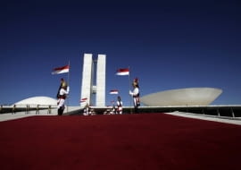 Presidential guards called the Dragons of Independence stand at guard in front of the Brazilian National Congress, designed by architect Oscar Niemeyer, during a welcoming ceremony in Brasilia April 7, 2010. The dream was big. In just a few years, Brazil would build a modern capital in the middle of a savanna, an experiment in egalitarianism that would also shift power toward the center of the vast country. As Brasilia turned 50 years old on April 21, 2010, vestiges of that dream live on in Oscar Niemeyer's soaring architecture, the uniform residential apartment blocks, and the plane-like city shape that legend has it was meant to signal the Latin American giant's take-off. Picture taken April 7. To match Feature BRAZIL-BRASILIA/ REUTERS/Ricardo Moraes (BRAZIL - Tags: ANNIVERSARY CITYSCAPE)
