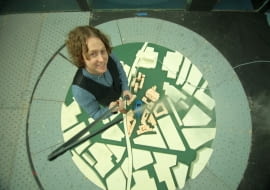 ULeeds (Bridgewater Place) - Birds eye shot of Justin towering over small scale model.