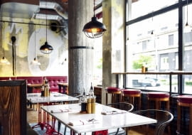 Industrialny klimat Betonowe filary, surowa cegła, drewno z odzysku w zestawieniu z kolorowymi meblami nie wydają się chłodne.