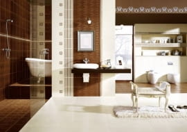 Część ścian wyłożono płytkami z roślinnym wzorem. Stylizowana wanna i nablatowa umywalka podkreślają styl łazienki.