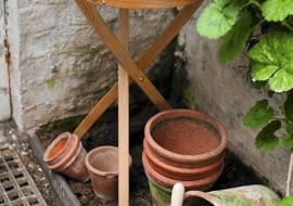 Wooden Table with Cut Flowers and Garden String with Terracotta Plant Pots and Geranium Foliage (Pelargonium)