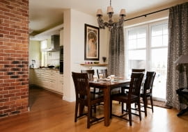 <B>Katarzyna i Łukasz marzyli o ciepłych, przyjaznych wnętrzach, jakie podziwiali w Toskanii i Prowansji. W nowym domu przywołali upragniony klimat.</B> <BR>W przestronnej strefie dziennej toczy się życie 5 osobowej rodziny. W sąsiedztwie kuchni, tuż przy wyjściu na taras, zaaranżowano kącik jadalny. Stół z drewna brzozy wybarwionej na orzech nie jest duży (nie zabiera więc miejsca), ale po rozłożeniu blat staje się dwa razy dłuższy. Podobnie jak krzesła stół ma ponadczasową formę, pasującą do wielu stylów. Meble te idealnie się więc zgrały z dodatkami o prowansalskim charakterze (np. lampy i zasłony).