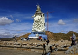 People work at the base of the Virgin of the Socavon (patron saint of miners) statue during its construction at the Santa Barbara hill in the outskirts of the Oruro, some 200 km (124 miles) south of La Paz, January 18, 2013. The statue measures 45 metres (148 feet) in height and stands at 3850 meters (12,631 feet) above sea level. The statue is expected to complete by February 2, 2013 according to its sculptors. REUTERS/David Mercado (BOLIVIA - Tags: RELIGION SOCIETY)