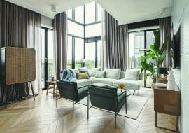 Prezentowany apartament zajmuje trzy kondygnacje. Dwie z nich tworzą 120-metrowe mieszkanie z częścią dzienną na parterze i prywatną z pokojami domowników na piętrze. Trzecią kondygnację zajmuje ogród o powierzchni 44 m2. W salonie kompozycja różnych w formie i wykończeniu foteli, sofy, stolików oraz szafek, zamiast jednorodnego kompletu mebli, tworzy atmosferę swobody, niepozbawionej elegancji.