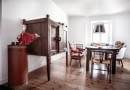 Chiński kabinet, stół z litego, egzotycznego drewna z Indonezji, obok sofa biedermeier i kolekcja krzeseł m.in. projektu Hansa J. Wegnera (model nr 24) oraz Charlesa i Ray Eamsów (DSR), oba z 1950 roku.