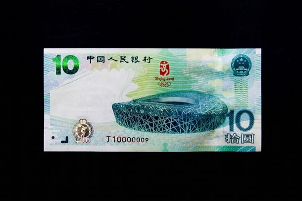 BEIJING - JULY 08: The front of the new 10-yuan commemorative bank note on July 8, 2008 in Beijing, China. The People's Bank of China (PBOC), the country's central bank, will issue a commemorative bank note with a face value of 10 yuan ($1.46) on Tuesday to mark the Beijing Olympic Games. On one side is a picture of the National Stadium, known as the Bird's Nest, the main venue for the Olympic Games in August. The other side of the note has an illustration of the famous ancient Greek marble statue of a discus-thrower, Discobolus, portraits of athletes and the Arabic numeral "2008". The PBOC said it would issue a total of 6 million commemorative notes, which would be circulated in the currency market with the same denomination as the regular 10-yuan notes. (Photo by Feng Li/Getty Images)