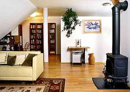 Ściana na prawo od kolumny (elementu konstrukcyjnego poddasza) oddziela część "publiczną" mieszkania od prywatnej. Przerobiona na stolik maszyna do szycia służyła kiedyś babci pana domu