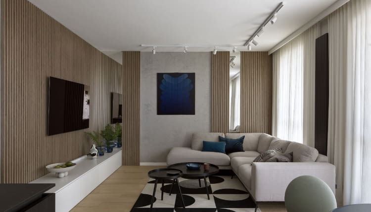 Honorowe miejsce w salonie zajmuje obraz Andrzeja Jana Batora. Granatowe akcenty kolorystyczne na tle bieli, szarości i ciepłej barwy drewna pojawiają się niemal w każdym pomieszczeniu mieszkania.