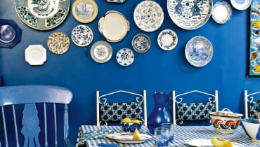 Z DAWNYCH LAT. Najcenniejsza historyczna porcelana (Miśnia, Royal Copenhagen, Furstenberg) była malowana na kobaltowo. Modern blue dining room table chairs check pattern cloth ceramic wall plates interiors rooms cool colours display collections