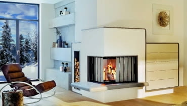 Kominek ze specjalną osłoną termiczną wykonaną z metalu, którą w razie potrzeby rozsuwa się przed szybą, co zapobiega przegrzewaniu salonu Kominek ze specjalną osłoną termiczną wykonaną z metalu, którą w razie potrzeby rozsuwa się przed szybą, co zapobiega przegrzewaniu salonu