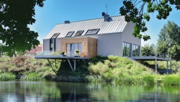 Budynek stoi na wzniesieniu, celowo zarośniętym nieusuwanymi przez właścicieli chwastami dom jednorodzinny