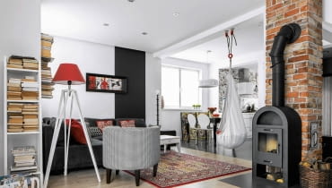 Otwarta przestrzeń została podzielona na strefy. Wąską paletę barwną uzupełniono o akcenty nasyconej czerwieni. Dom wnętrza dla rodziny, salon, urządzanie wnętrz, aranżacja wnętrz