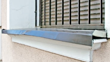 Blaszany parapet zniekształcony przez wysoką temperaturę