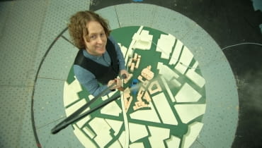 Justin Cunningham ULeeds (Bridgewater Place) - Birds eye shot of Justin towering over small scale model.
