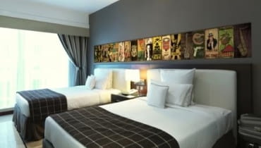 Po kolorowych tynkach, wzorzystych tapetach i fantazyjnych naklejkach przyszedł czas na... blachy. Są one oryginalną alternatywą w dekorowaniu ścian w mieszkaniach i domach. Dzięki możliwości tworzenia intrygujących kolaży usatysfakcjonują nawet miłośników sztuki. <BR > Do produkcji dekoracyjnych blach manufaktura PosterPlate wykorzystuje technologię sitodruku (serigrafia). To tradycyjna metoda, której stosowanie zostało zapoczątkowane w X wieku w Chinach. Każdy z wybranych kolorów jest nakładany ręcznie przy pomocy rakla - jest to rodzaj twardego gumowego narzędzia - przeciskając farbę na blachę poprzez sito. By uzyskać obraz używa się wielu sit z odwzorowanym szablonem danej warstwy (koloru). Ostateczny efekt powstaje po ręcznym nałożeniu wszystkich kolorów. Przed drukiem poszczególnych warstw, półprodukty są suszone przez kilka godzin w sterylnych warunkach. Druk każdego następnego koloru jest poprzedzony starannym dopasowaniem sita, do wcześniej nałożonych barw. Na zdjęciu - sypialnia udekorowana ozdobną blachą.