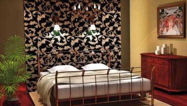 Projekt wnętrza 1. Ścianka za łóżkiem wyłożona tapetą w wyrazisty stylowy wzór stała się główną ozdobą tego wnętrza. Na ścianie zainstalowano dwa kinkiety - przy ich świetle można poczytać przed snem.