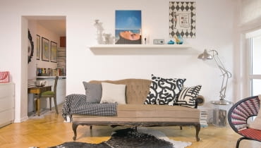 <B>Najprostszym kluczem do stworzenia nastroju jest umiejętnie dobrany detal. Błyskawiczna metamorfoza tego mieszkania udowadnia, że wystarczy naklejka, naczynie w odpowiednim kolorze, rozrzucone tu i ówdzie bombki lub jabłka, kilka figurek i od razu widać, że święta są tuż za progiem. W dodatku jest to patent uniwersalny. Tak samo łatwo przeobrazimy wnętrze na powitanie wiosny albo na urodziny babci.</B> <BR />SALON PRZED ZMIANĄ. Na co dzień w pokoju dziennym panuje stylowa mieszanka: przepastna kanapa w stylu retro i fotel z lat 50. z wyplatanym z tworzywa sztucznego siedziskiem. We wnętrzu dominują chłodne odcienie beżu i niebieskiego, do tego kropla czerni, a w tle biel. <B>Najprostszym kluczem do stworzenia nastroju jest umiejętnie dobrany detal. Błyskawiczna metamorfoza tego mieszkania udowadnia, że wystarczy naklejka, naczynie w odpowiednim kolorze, rozrzucone tu i ówdzie bombki lub jabłka, kilka figurek i od razu widać, że święta są tuż za progiem. W dodatku jest to patent uniwersalny. Tak samo łatwo przeobrazimy wnętrze na powitanie wiosny albo na urodziny babci.</B> <BR />SALON PRZED ZMIANĄ. Na co dzień w pokoju dziennym panuje stylowa mieszanka: przepastna kanapa w stylu retro i fotel z lat 50. z wyplatanym z tworzywa sztucznego siedziskiem. We wnętrzu dominują chłodne odcienie beżu i niebieskiego, do tego kropla czerni, a w tle biel.