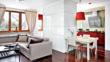 KUCHNIA. Za białymi frontami od strony pokoju kryją się schowki, m.in. barek. Dolne szafki kuchenne z lakierowanej na czerwono płyty MDF są przykryte blatem z konglomeratu kwarcowego - bardzo twardego, odpornego na ścieranie i działanie wysokiej temperatury. KUCHNIA. Za białymi frontami od strony pokoju kryją się schowki, m.in. barek. Dolne szafki kuchenne z lakierowanej na czerwono płyty MDF są przykryte blatem z konglomeratu kwarcowego - bardzo twardego, odpornego na ścieranie i działanie wysokiej temperatury.