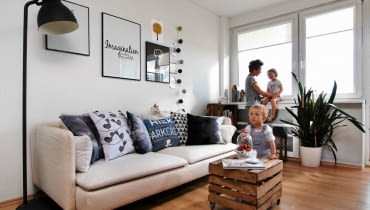SALON. Ścianę nad kanapą zdobią plakaty w metalowych ramach oraz kartki z sentencjami (pani Urszula wybiera te maksymy, które ją inspirują i wprowadzają całą rodzinę w dobry nastrój). Zaletą takiej dekoracji jest to, że łatwo ją wymienić - kartki są przyklejone do ściany za pomocą ozdobnej taśmy (washi tape). OLYMPUS DIGITAL CAMERA