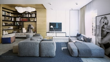 Dwie niskie sofy zachęcają do odpoczynku, a zastosowanie kolorów niebieskiego i szarego w przyjemnych odcieniach połączone z ciepłym drewnem tworzą relaksacyjny nastrój. W części bibliotecznej lampa w kształcie chmury Nemo Nuvola.