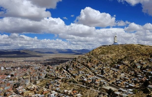 A general view of part of Oruro city and the Virgin of the Socavon (patron saint of miners) statue during its construction at the Santa Barbara hill, some 200 km (124 miles) south of La Paz, January 18, 2013. The statue measures 45 metres (148 feet) in height and stands at 3850 meters (12,631 feet) above sea level. The statue is expected to complete by February 2, 2013 according to its sculptors. REUTERS/David Mercado (BOLIVIA - Tags: RELIGION SOCIETY)