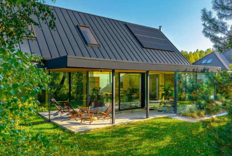 Budynek od strony ogrodu zaopatrzono w obszerne okna tarasowo-ogrodowe. Dzięki nim ze środka otwierają się efektowne widoki na naturalne sąsiedztwo, a z kolei z zewnątrz powstaje miejscami iluzja przeszklenia parteru domu na przestrzał Budynek od strony ogrodu zaopatrzono w obszerne okna tarasowo-ogrodowe. Dzięki nim ze środka otwierają się efektowne widoki na naturalne sąsiedztwo, a z kolei z zewnątrz powstaje miejscami iluzja przeszklenia parteru domu na przestrzał