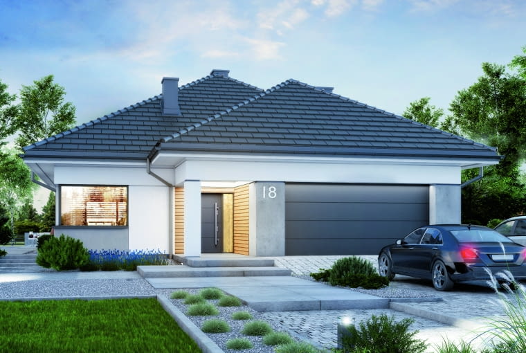 Część dzienna łączy się przez szerokie przesuwne przeszklenie z zadaszonym tarasem. Projekty domów parterowych