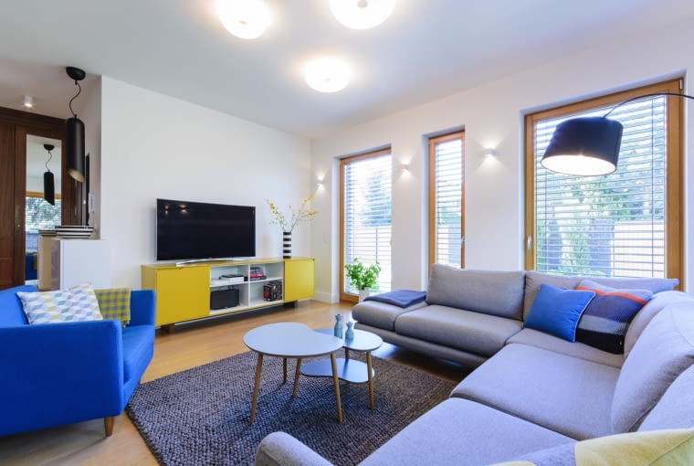 W wyniku estetycznych zabiegów projektantki wnętrz, część wypoczynkowa z salonem i jadalnią jest jasna, przestronna i zgodna z wyobrażeniami właścicieli.]