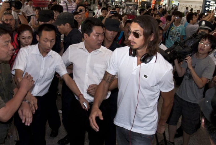 Zlatan Ibrahimović AC Milan soccer player Zlatan Ibrahimovic, right, is shown the way by Chinese official upon arrival at the Beijing Capital International Airport in Beijing, China, Tuesday, Aug. 2, 2011. AC Milan will play with Inter Milan at the Italian Super cup soccer match in Beijing Saturday. (AP Photo/Andy Wong)