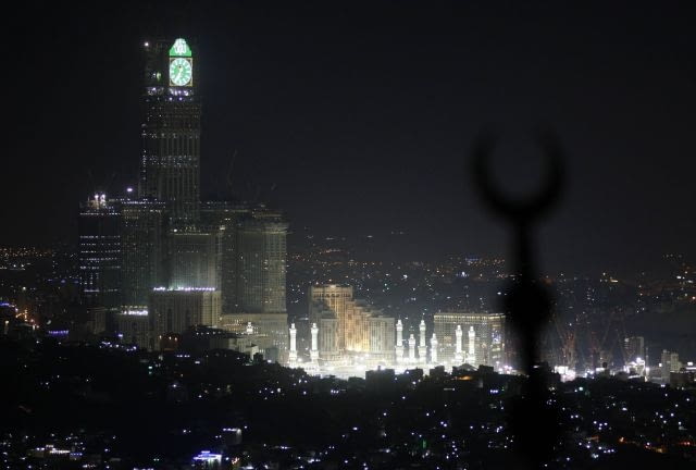The Grand Mosque and the four-faced clock, atop the Abraj Al-Bait Towers are seen from the top of al-Noor mountain where the Hiraa cave is located, overlooking the Saudi holy city of Mecca, Saudi Arabia, Thursday, Nov. 11, 2010. The annual Islamic pilgrimage draws 3 million visitors each year, making it the largest yearly gathering of people in the world.(AP Photo/Hassan Ammar)