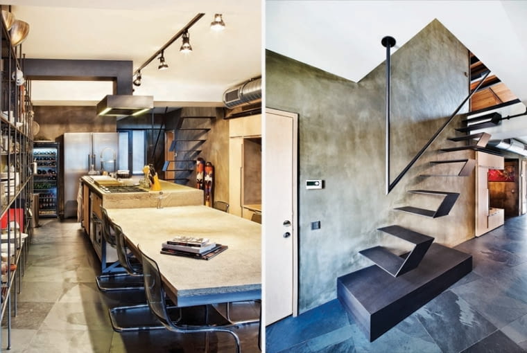 Długa kuchnia w stylu industrialnym z centralnie ustawionym stołem i wyspą kuchenną (po lewej). Minimalistyczne schody prowadzące na antresolę (po prawej). loft, apartament w stylu industrialnym