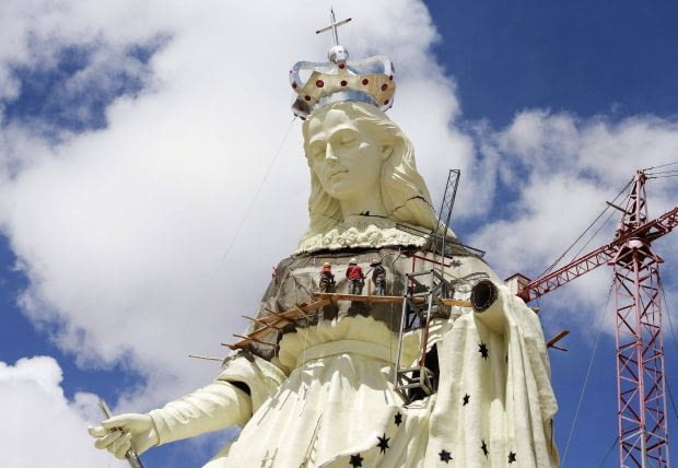 People work on the Virgin of the Socavon (patron saint of miners) statue during its construction at the Santa Barbara hill in the outskirts of the Oruro, some 200 km (124 miles) south of La Paz, January 18, 2013. The statue measures 45 metres (148 feet) in height and stands at 3850 meters (12,631 feet) above sea level. The statue is expected to complete by February 2, 2013 according to its sculptors. REUTERS/David Mercado (BOLIVIA - Tags: RELIGION SOCIETY TPX IMAGES OF THE DAY)