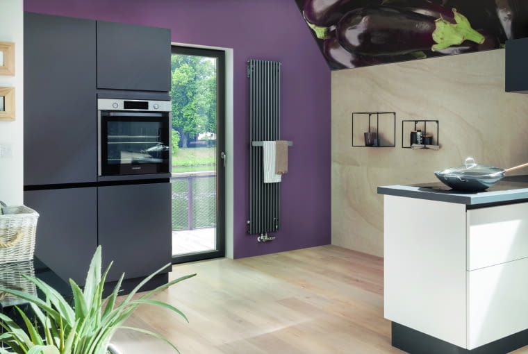 Okrągłe pionowe rury nadają temu grzejnikowi przejrzysty, harmonijny wygląd. Standardowo wyposażony jest w asymetryczny wieszak, który pełni zarówno funkcję praktyczną, jak i dekoracyjną. Wieszak dostępny jest w jednej z trzech wersji – drewno, stal polerowana lub stal szczotkowana