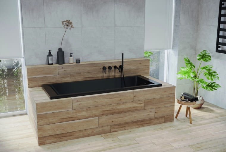 Niewielka wanna w matowej czerni pozwoli maksymalnie wykorzystać przestrzeń, a w takiej obudowie doda aranżacji przytulności
