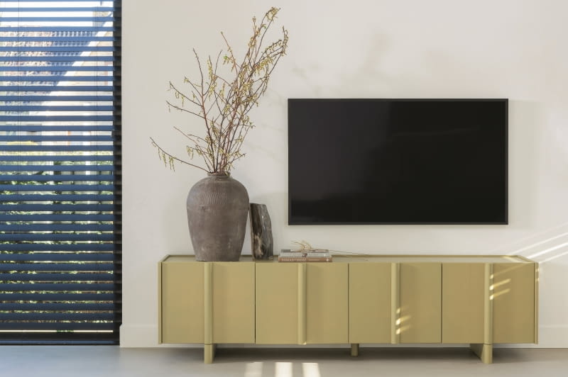 Drewniana szafka Basu dostępna jest w kilku barwach, można więc wybrać idealny mebel do swojego wnętrza. Tutaj w kolorze zielonego mchu.