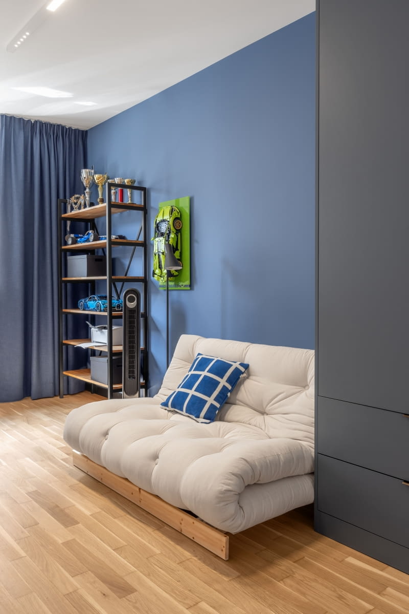 Rozkładana sofa typu futon, która może służyć zarówno gościom, jak i jako miejsce krótkiego odpoczynku od pracy.