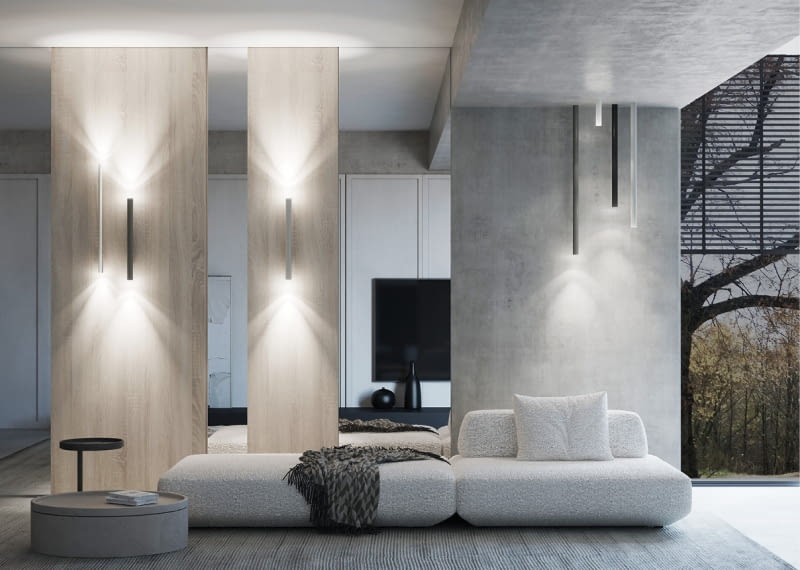 W przestronnym salonie z wysokim sufitem ściany o znaczącej powierzchni mogą przytłaczać. Unikniemy tego wrażenia, dzieląc je na fragmenty, na przykład z pomocą wielkoformatowych płyt meblowych i tafli luster. Zaś światło nowoczesnych lamp całość ociepli i poprawi proporcje.