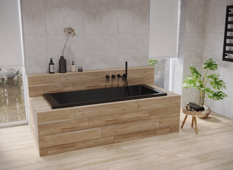 Niewielka wanna w matowej czerni pozwoli maksymalnie wykorzystać przestrzeń – w takiej obudowie doda aranżacji przytulności.