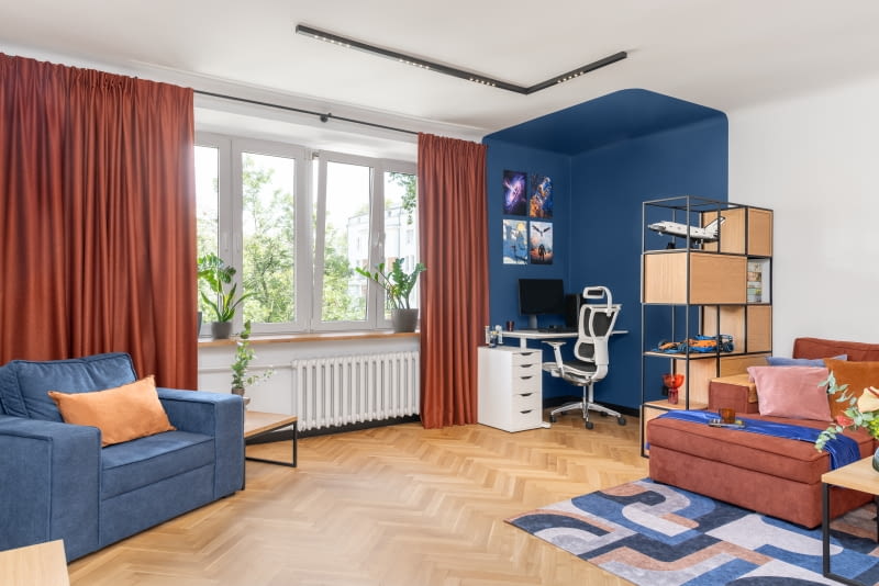 Granatowe ściany i sufit wyraźnie wydzielają strefę do pracy i gry na komputerze.