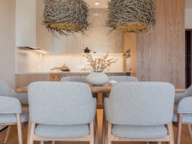 Mocnym akcentem tej przestrzeni są dwie duże, zawieszone nad stołem lampy w stylu boho ze sklepu Atria – plecione niczym ptasie gniazda z naturalnej trawy morskiej.