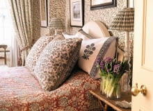 A detail of a traditional bedroom with William Morris pattern wallpaper and curtains, double bed, pattern cover SLOWA KLUCZOWE: square image